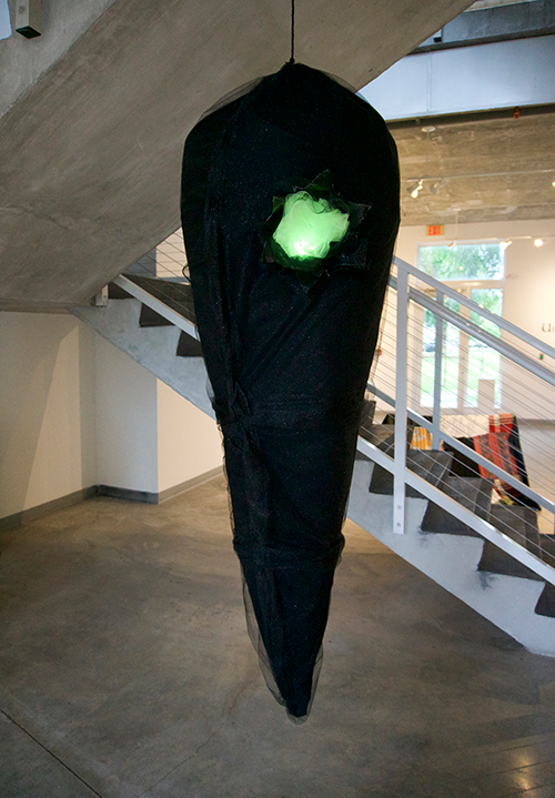 “Chrysalis,” created by artist and curator of the “In the Dark” exhibition Angela Yang. The piece is meant to represent the symbolic transformation a person goes through during difficult times. (Photo by Angela Yang)
