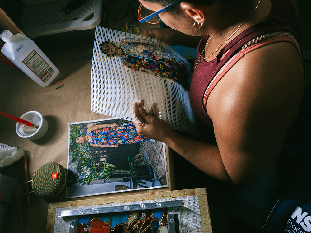 Artist Kandy Lopez uses a variety of mediums and materials to create her portraits. (Photo by Jade Lily)