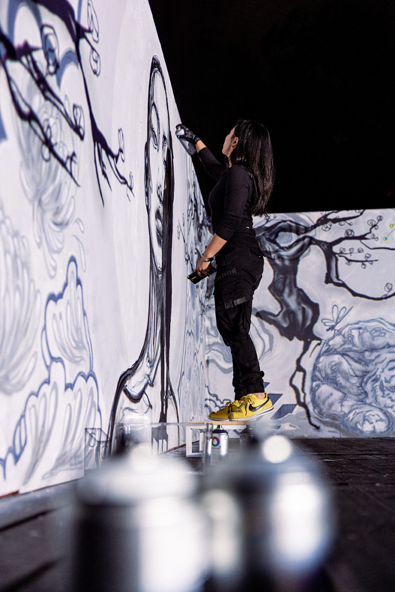 Kalis live painting the first version of her piece, “Fast Forward,” at IGNITE Broward 2024. (Photo by Rosanna Kalis)