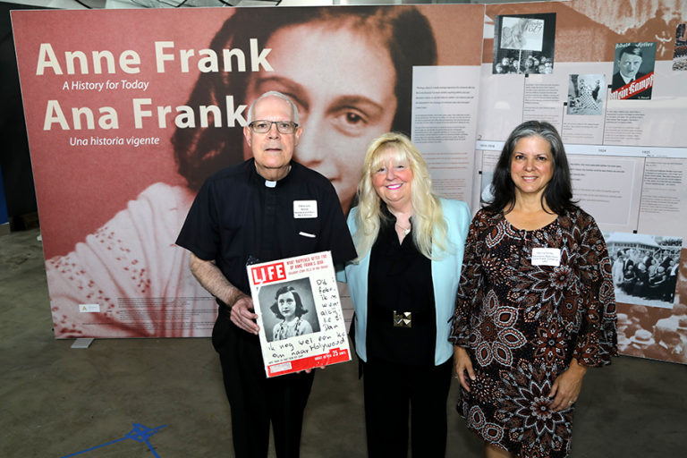 Father John Neiman, Rositta E. Kenigsberg, president of The Holocaust Documentation and Education Center, and Donna Tarney from the Anne Frank Center at the opening of the Anne Frank Exhibition on Nov. 11, 2024. (Photo by The Holocaust Documentation and Education Center)