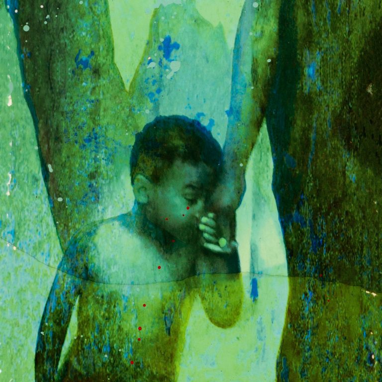 A young child is bathed in a vivid green glow, their figure cast in soft focus against a misty backdrop. The image is part of the “Ancestor Spirits” series projected onto historic building windows, reminding viewers of generations whose legacies are often unseen yet ever-present. This was envisioned and led by Marjorie Guyon, with photography executed by Patrick J. Mitchell. (Photo courtesy of Marjorie Guyon)