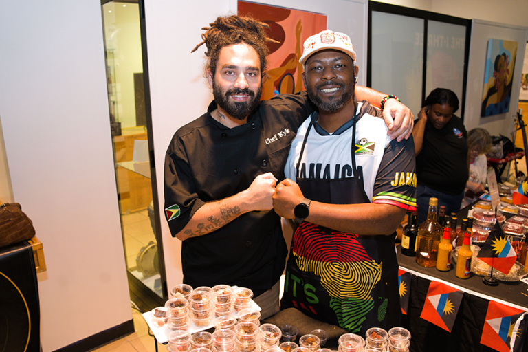 592 Chew (Guyana) and Miko Atkinson (Jamaica) hang out while Wadadli Kitchen (Antigua and Barbuda) preps in the background during Rum Cake Fest 2024 (Photo by Christian Ossohou, Island Syndicate, courtesy of Island SPACE Caribbean Museum).