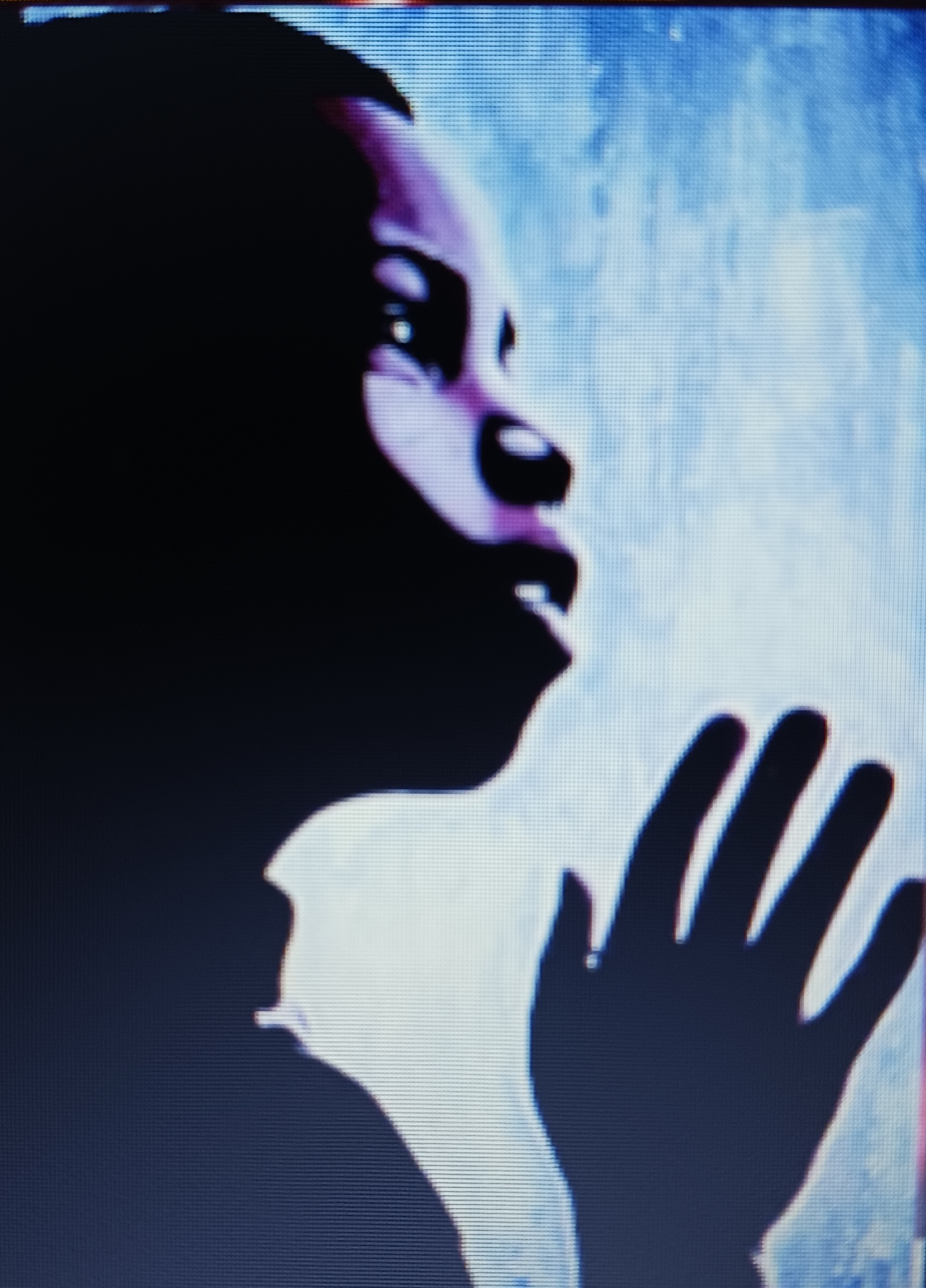 This image of my work depicts a young boy staring out of a window at life in motion