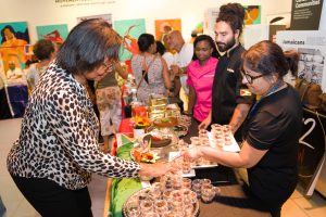 Woman serving cake sample at Rum Cake Fest
