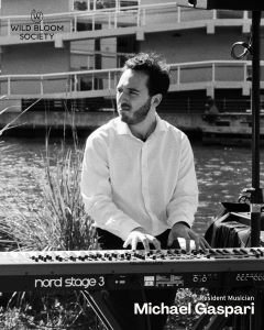 Resident Musician, Michael Gaspari playing Nord Stage 3 keyboard by waterfront with Wild Bloom Society logo and "Resident Musician Michael…