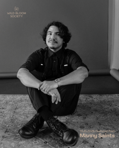 Wild Bloom Society 10.21.2026 Featured Poet Manny Saints, black and white portrait of person sitting on patterned floor we…